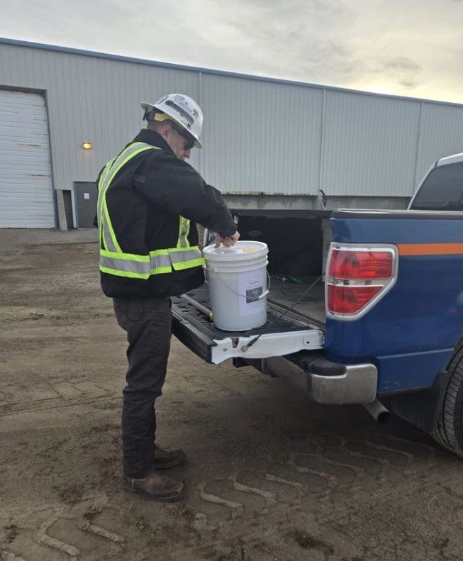 Worker loading bucket pickup truck industrial